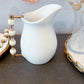 White Ceramic Pitcher with White and Gold Handle