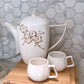 White and Gold lidded Teapot w/ Floral Details